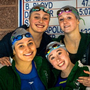 Swimmers takin a photo on the block after a race.